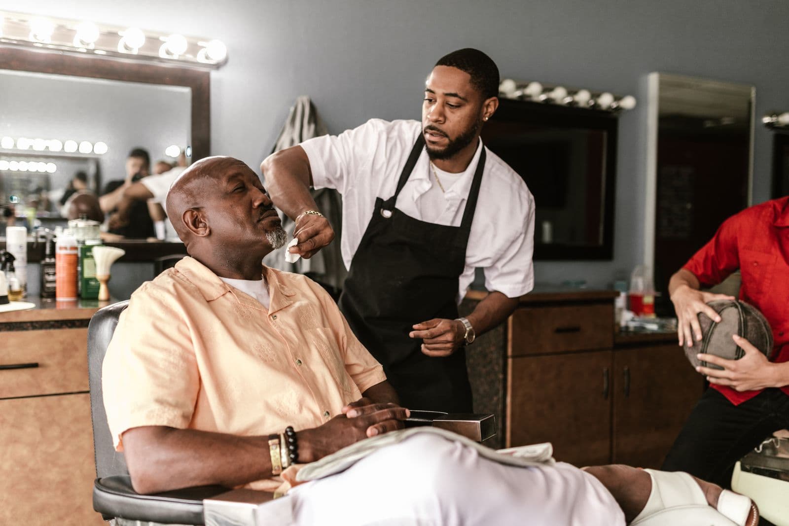 Barber shaving a client in an independent barbershop