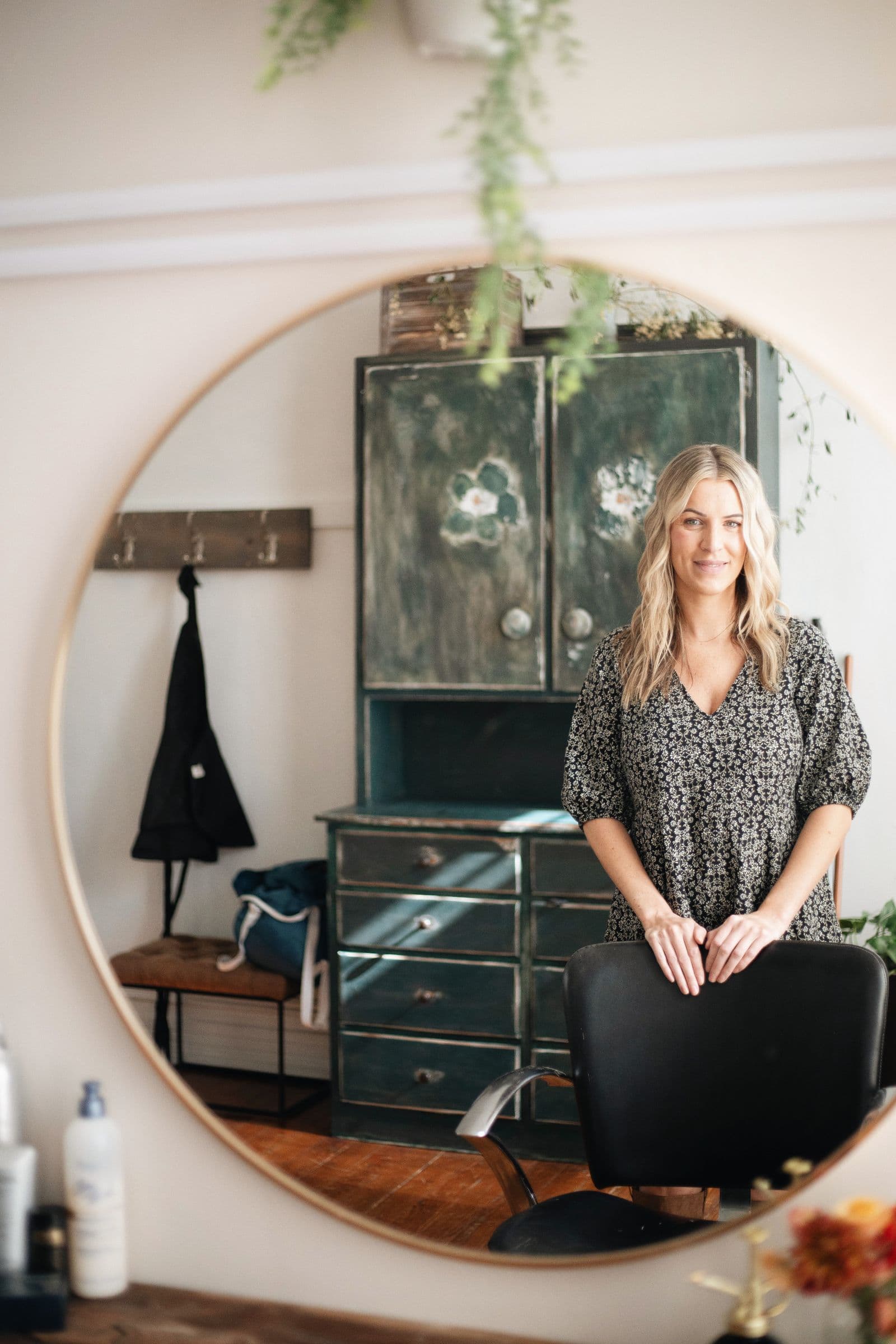 Salon owner beside the mirror at her workstation
