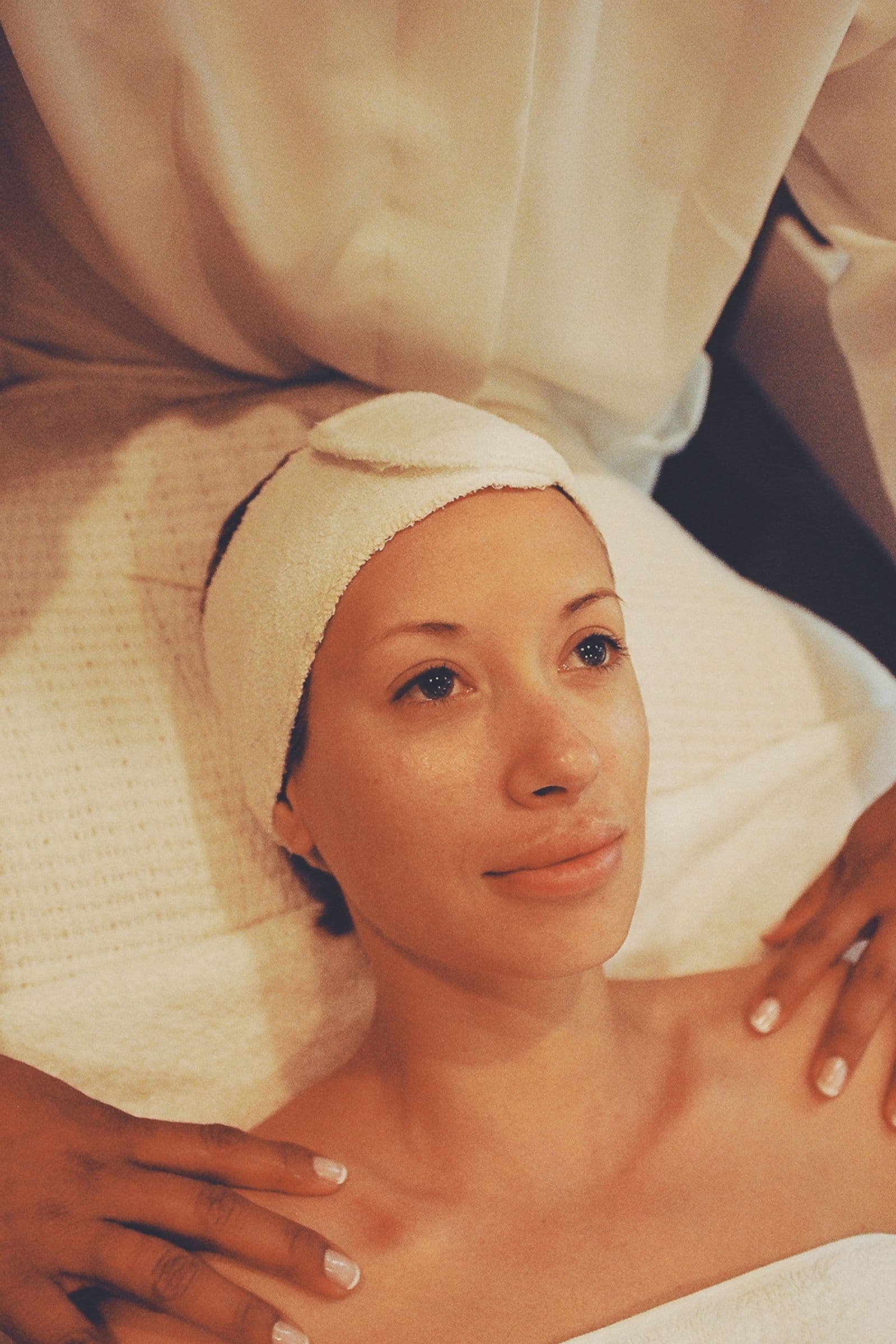 Professional performing a facial treatment in a spa